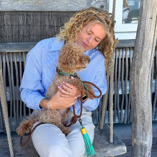 Close-up van hond Rover met een unieke handgemaakte DWAM halsband; de messing hardware en turquoise tassel geven een luxe, bohemian uitstraling.